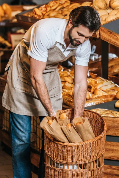 Assistente di negozio maschio organizzare pasticceria fresca nel supermercato — Foto stock