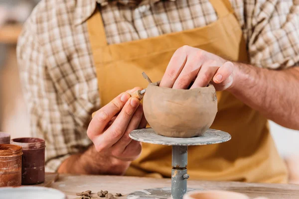 Cropped view of potter making ceramic bowl in workshop — Stock Photo