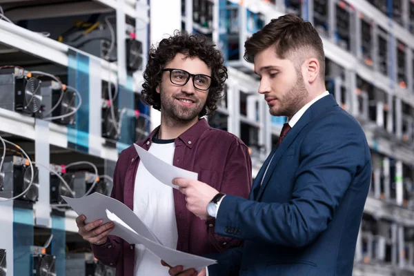 Successful businessman and computer engineer working together at ethereum mining farm — Stock Photo