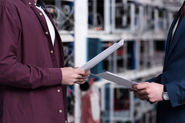 Cropped shot of businessman and computer engineer working together at bitcoin mining farm — Stock Photo