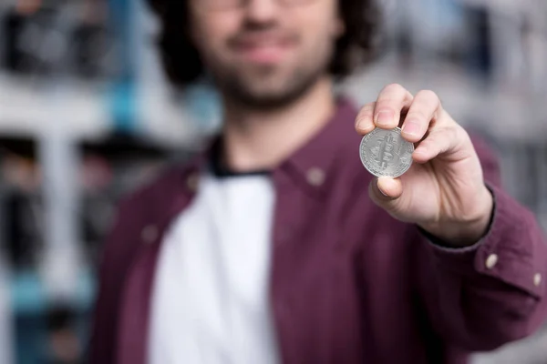 Close-up shot of computer engineer holding bitcoin — Stock Photo
