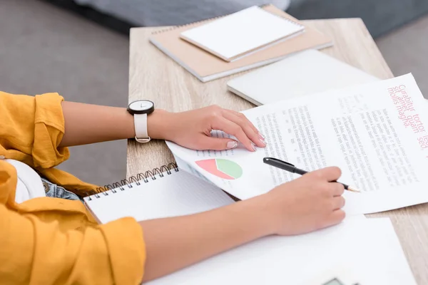 Cropped shot of woman doing paperwork at workplace — Stock Photo