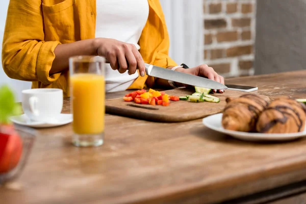 Colpo ritagliato di donna affettare cetriolo per insalata — Foto stock