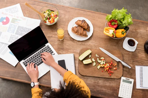 Top view of young woman working at home during breakfast — Stock Photo