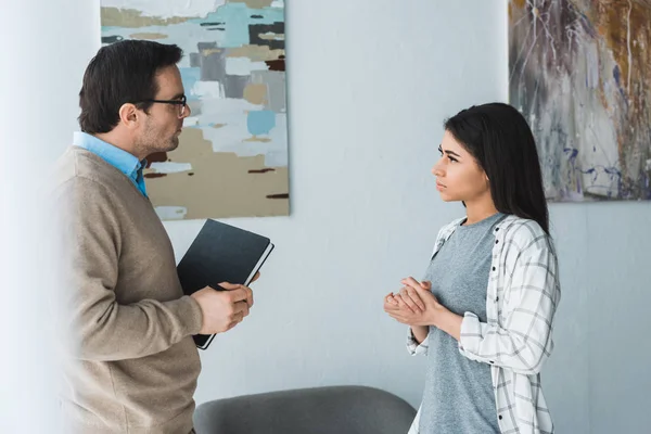 Female patient in depression talking to her therapist — Stock Photo