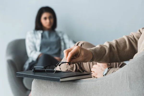 Close-up view of therapist putting glasses in front of female patient — Stock Photo