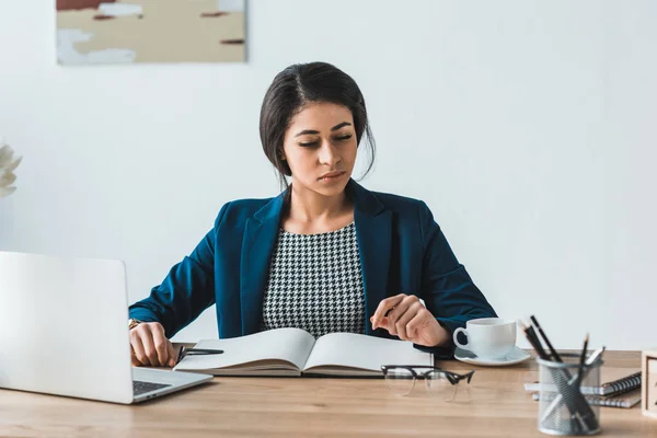 Empresária trabalhando por mesa com laptop em escritório leve — Fotografia de Stock