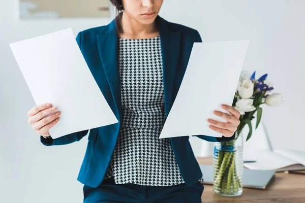 Close-up view of business documents in female hands — Stock Photo