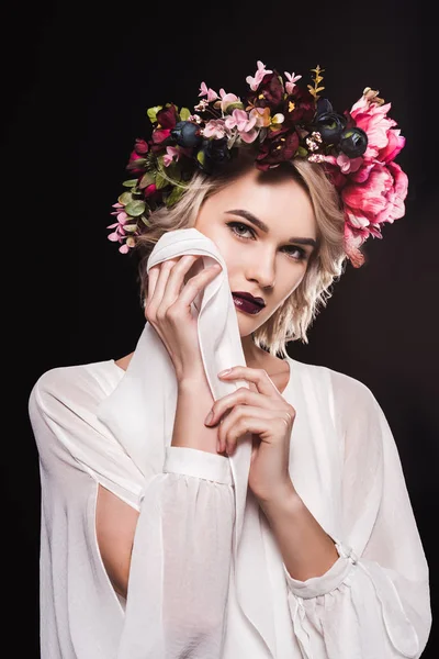 Fashionable blonde girl posing in white dress and flower wreath, isolated on black — Stock Photo