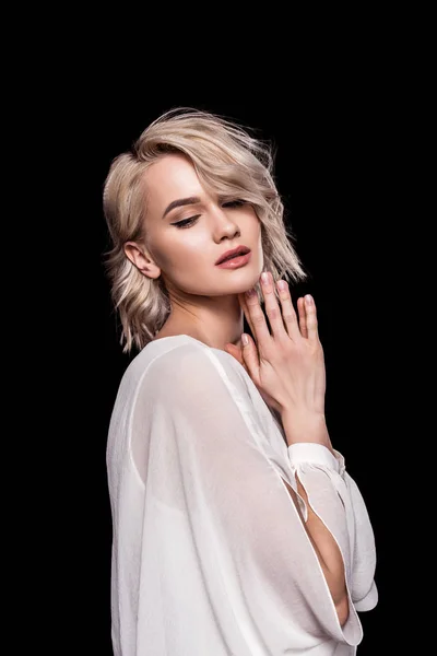 Attractive blonde girl posing in white dress, isolated on black — Stock Photo