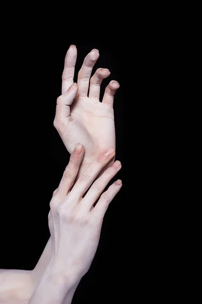 Cropped view of tender female hands in white powder, isolated on black — Stock Photo