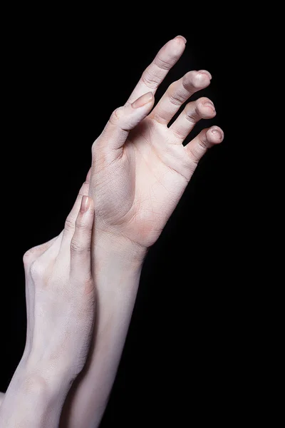 Cropped view of tender female hands, isolated on black — Stock Photo