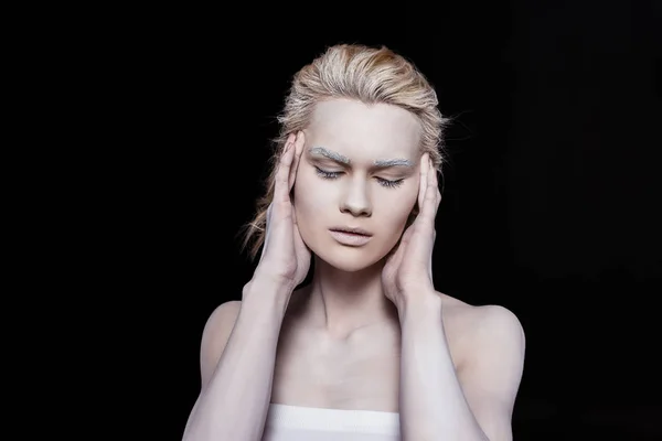 Jeune femme sensuelle posant avec du maquillage blanc, isolé sur noir — Photo de stock