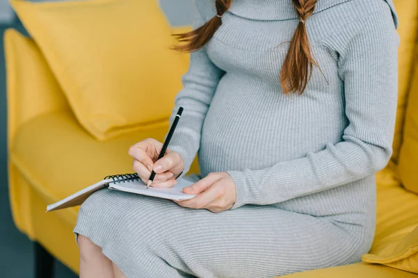 Pregnant woman writing — Stock Photo