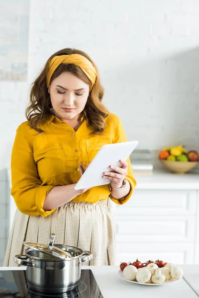 Belle femme utilisant tablette dans la cuisine — Photo de stock