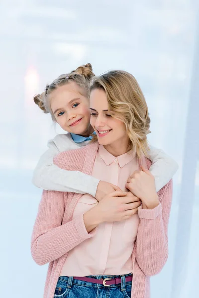 Happy daughter hugging mother at home — Stock Photo