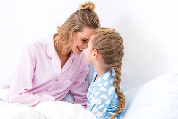 Happy mother and daughter touching with foreheads at home — Stock Photo