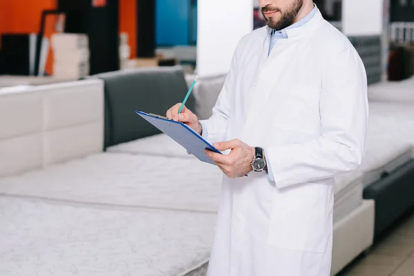 Assistant in white coat — Stock Photo