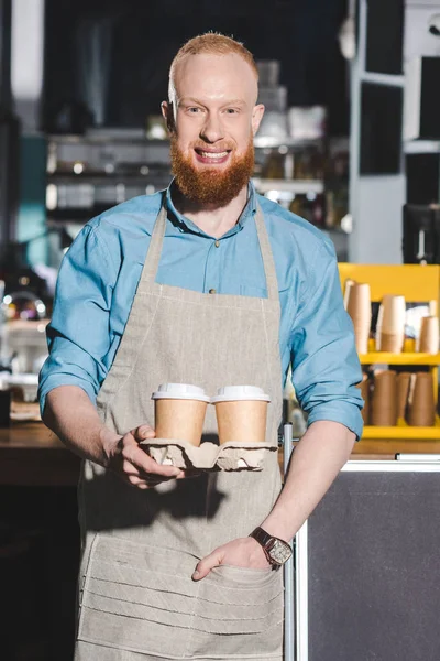 Sorridente barista maschio in possesso di due tazze monouso di caffè — Foto stock