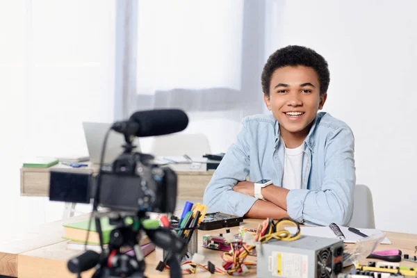 Smiling african american teenager shooting video blog at home — Stock Photo