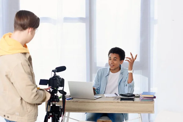 Multicultural teen boys shooting video blog with camera at home — Stock Photo