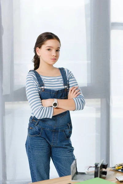 Preteen child standing with crossed arms and looking at camera at home — Stock Photo