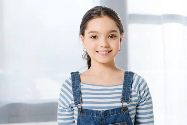 Adorable smiling preteen child looking at camera at home — Stock Photo