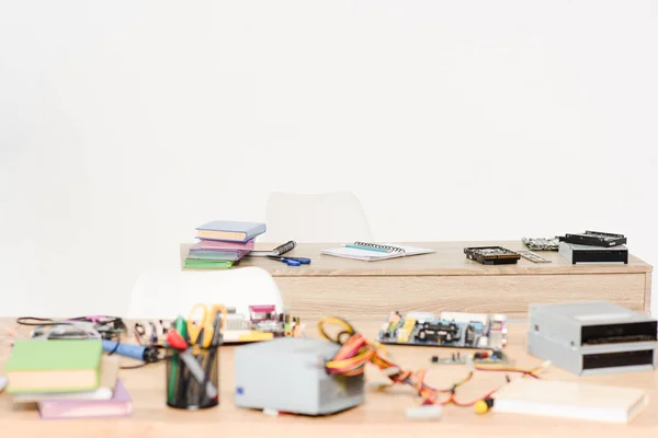 Computer power supply and motherboard on tables in living room — Stock Photo