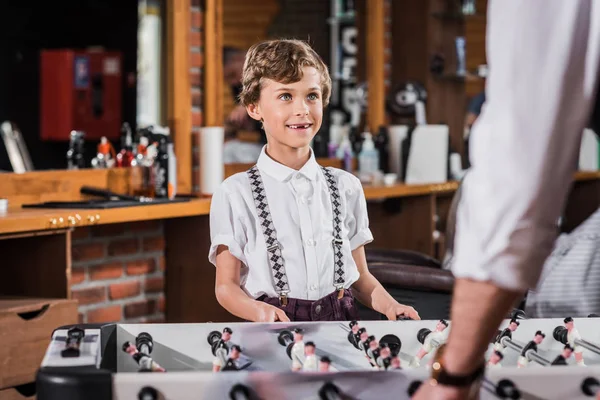 Happy little kid playing table football with father — Stock Photo