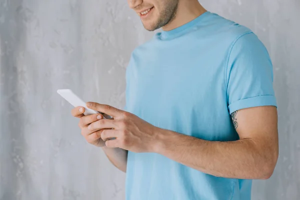 Close-up view of young man using smartphone — Stock Photo