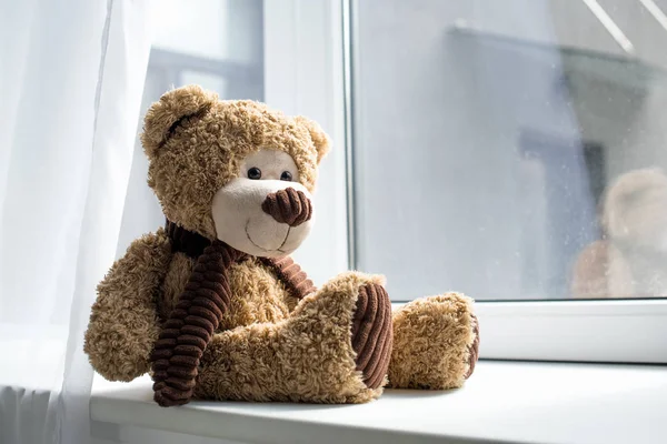 Close up view of cute teddy bear on window sill — Stock Photo