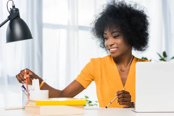 Smiling african american freelancer at workplace at home — Stock Photo