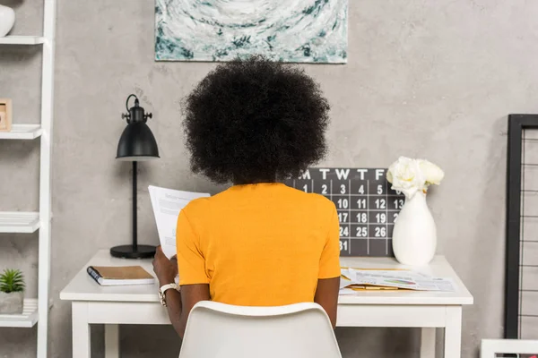 Back view of african american freelancer at workplace at home office — Stock Photo