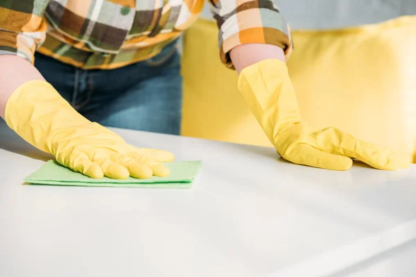 Abgeschnittenes Bild einer Frau, die zu Hause Tisch abstaubt — Stock Photo