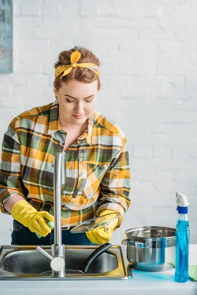 Hermosa mujer lavando platos en la cocina - foto de stock