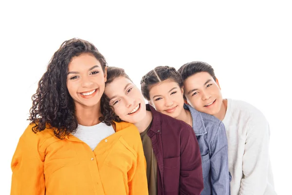 Portrait of cheerful multicultural teen friends leaning on each other isolated on white — Stock Photo