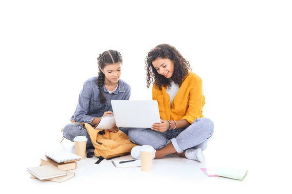 Adolescenti multiculturali utilizzando computer portatile insieme isolati su bianco — Foto stock