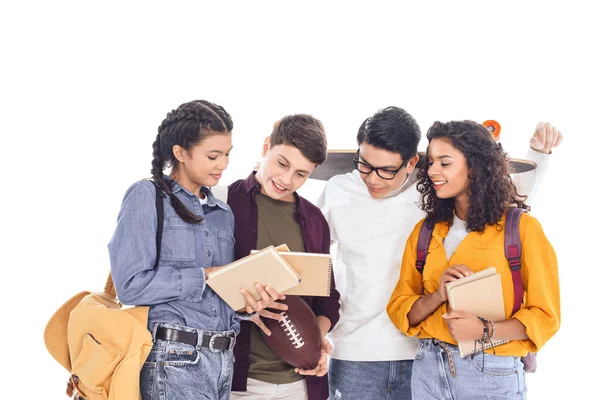 Portrait of smiling multicultural students with rugby ball and skateboard isolated on white — Stock Photo