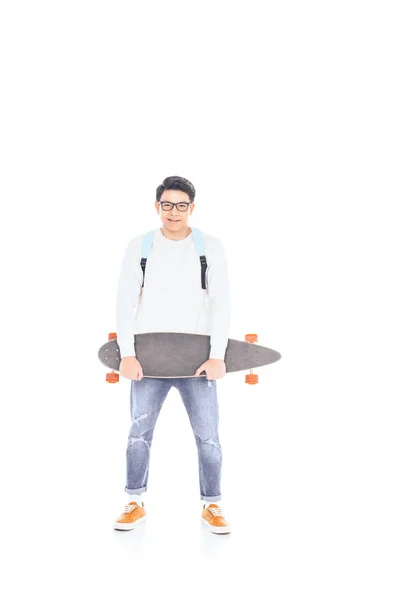 Asian teenager with backpack and skateboard isolated on white — Stock Photo