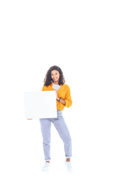 Smiling african american teenager with blank banner in hands isolated on white — Stock Photo