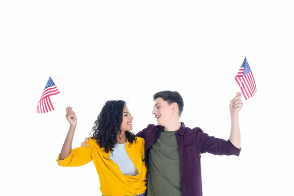 Embracing teenage students with american flags isolated on white — Stock Photo