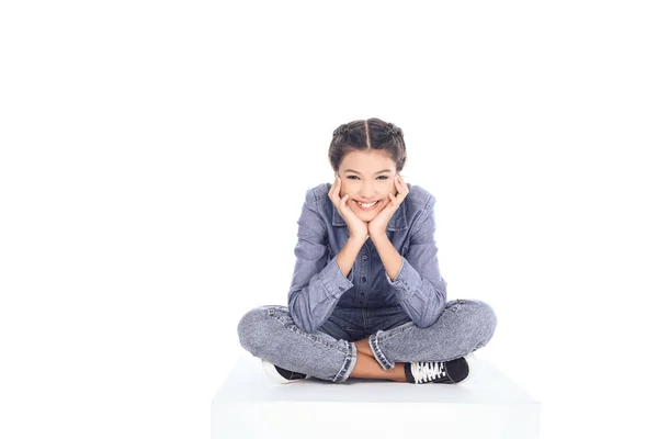Teenager-Studentin sitzt auf dem Boden und schaut auf Kamera isoliert auf weiß — Stockfoto