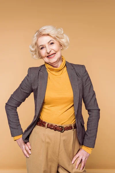 Élégant femme âgée posant isolé sur fond beige — Photo de stock