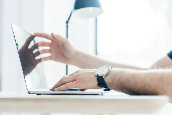 Partial view of person using laptop at workplace — Stock Photo