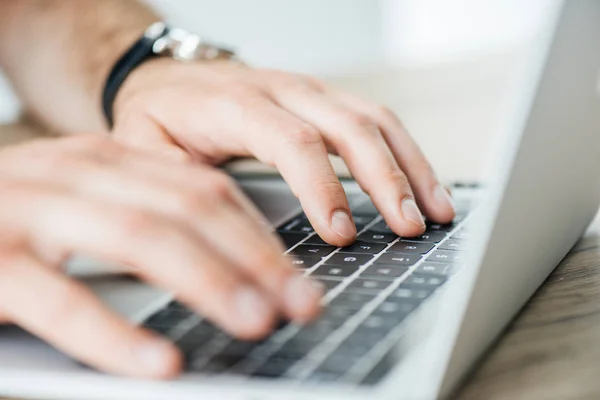 Cropped shot of person typing on laptop, selective focus — Stock Photo