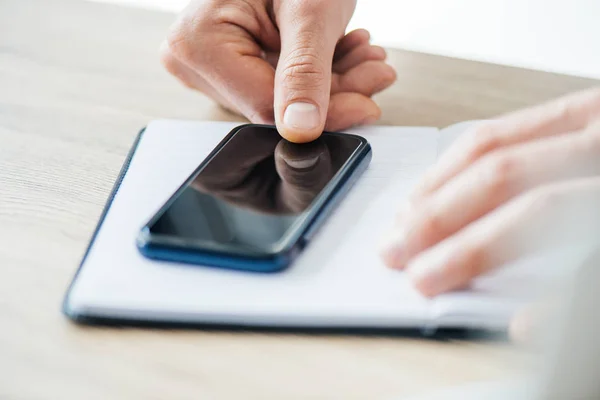 Close-up partial view of person using smartphone with blank screen, selective focus — Stock Photo