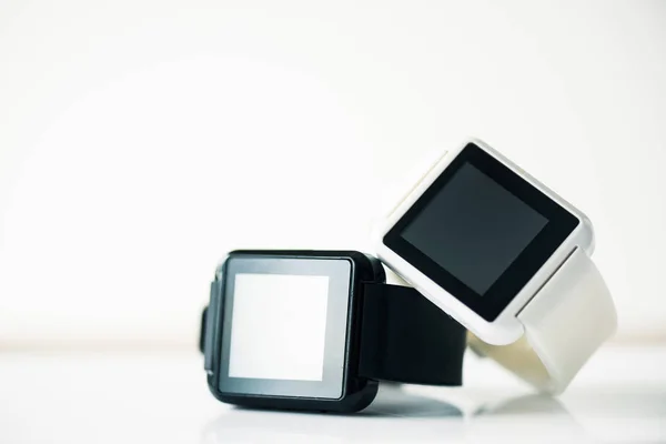 Close-up view of smartwatches with blank screens on grey — Stock Photo