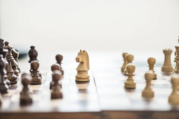 Vista de cerca de figuras de ajedrez de madera en tablero de ajedrez, enfoque selectivo - foto de stock
