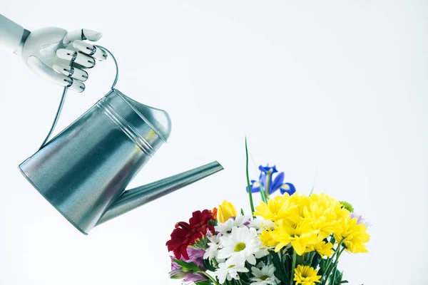 Hand of robot holding watering pot and beautiful bouquet of flowers isolated on white — Stock Photo