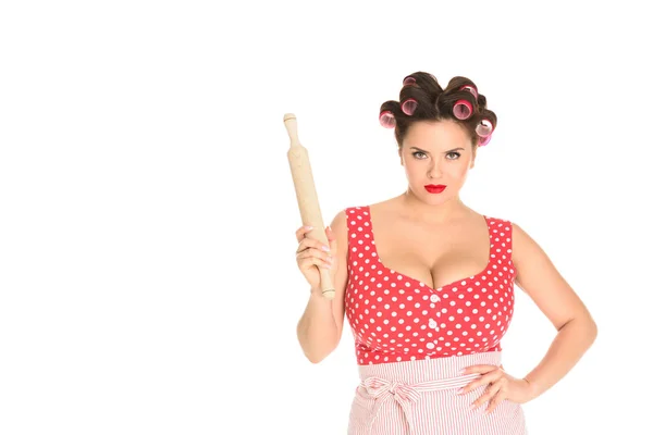 Angry plus size housewife with wooden rolling pin looking at camera isolated on white — Stock Photo